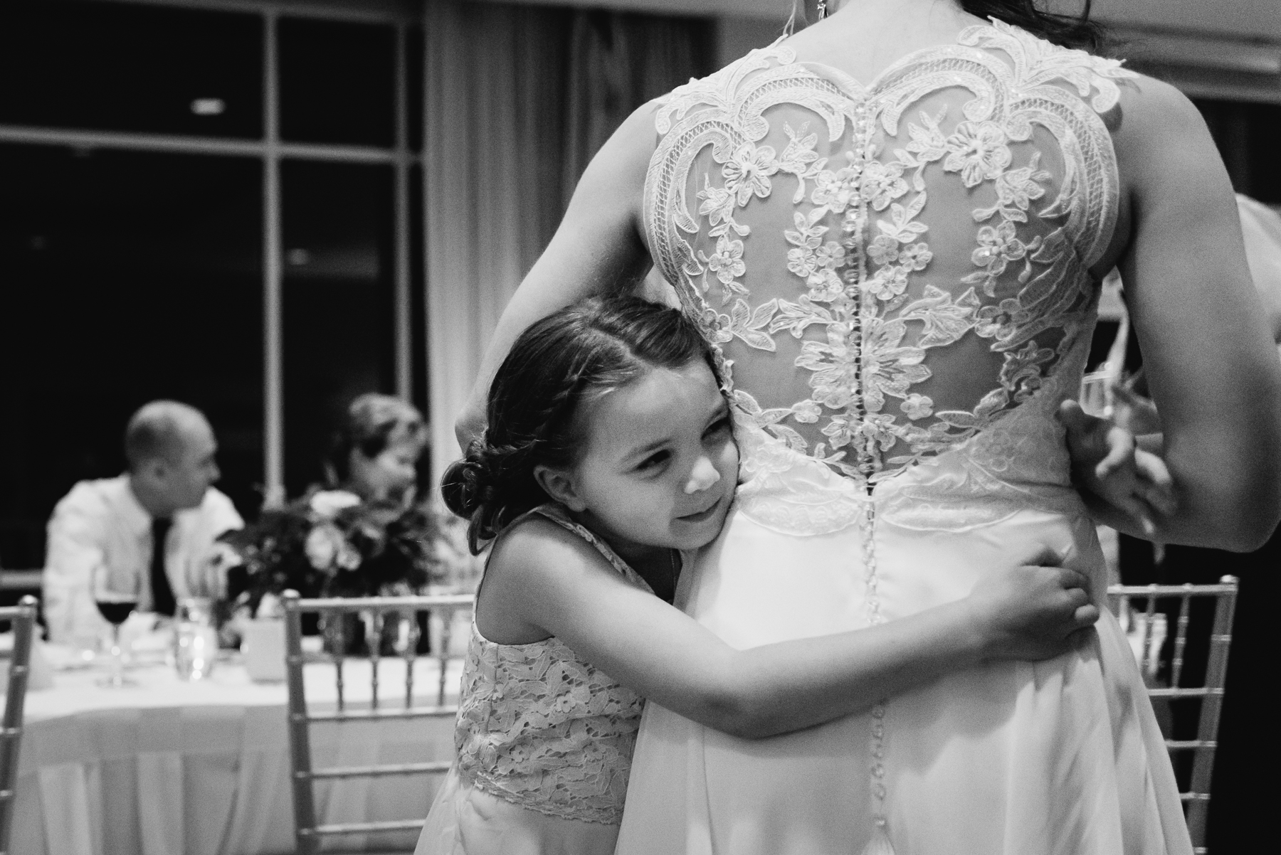 flower girl and bride hugging moment