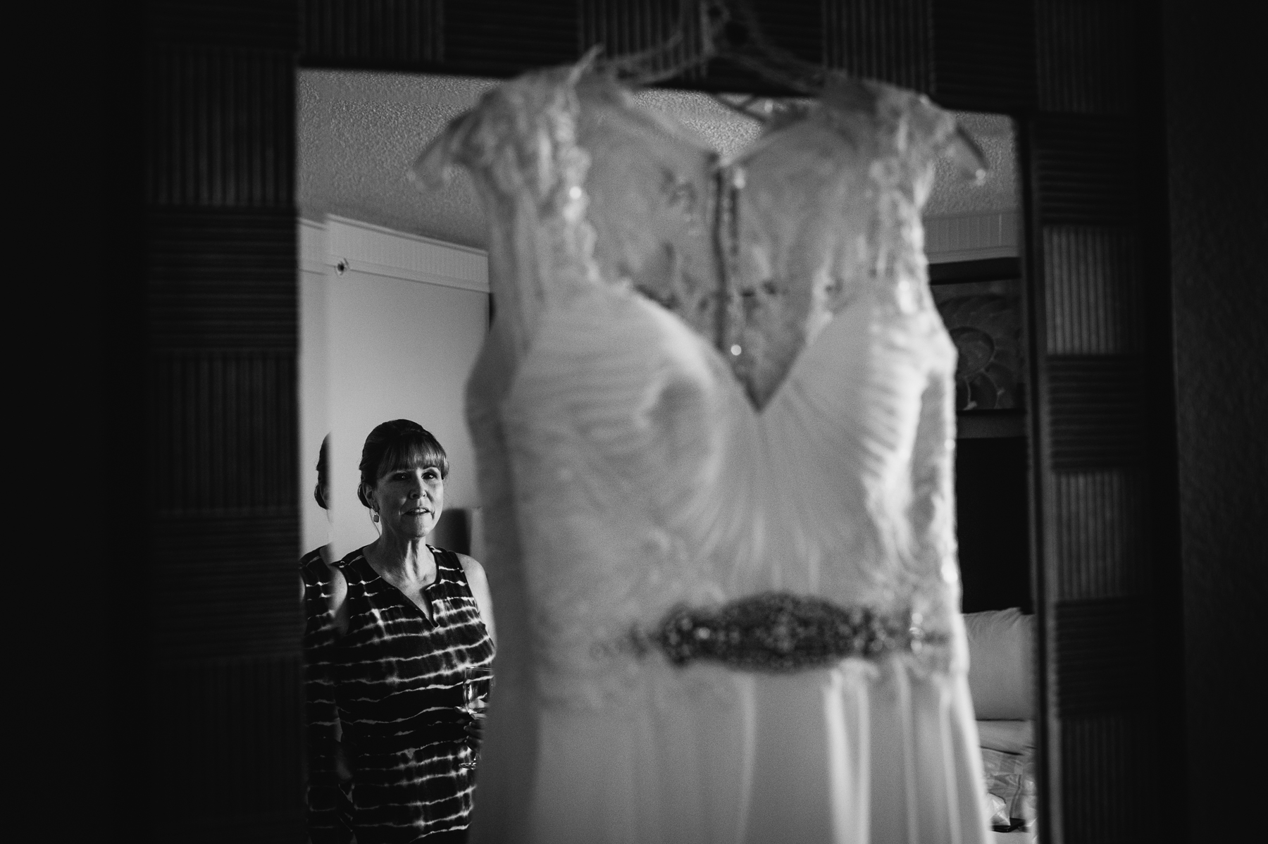 bride mom admiring daughters dress moment