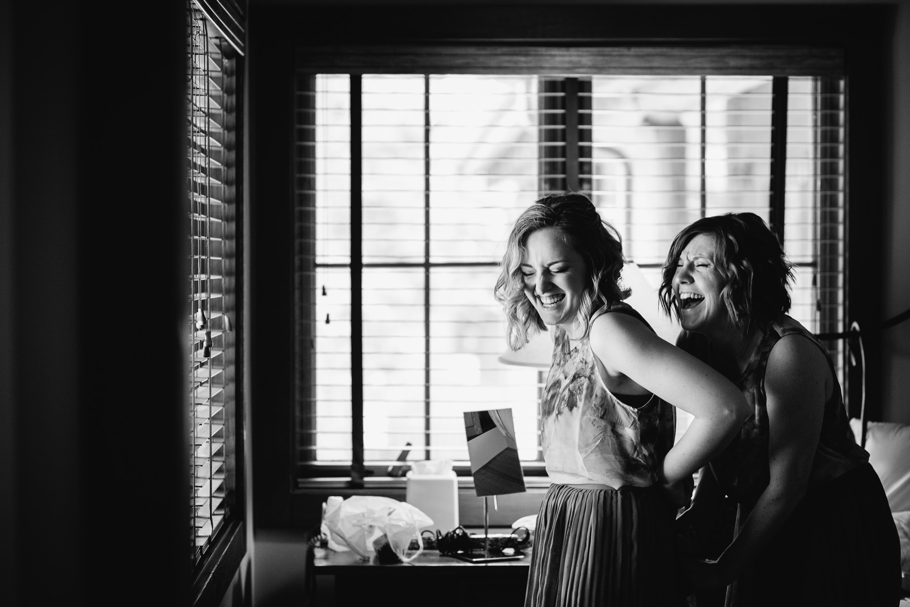 brides maids getting ready laughing