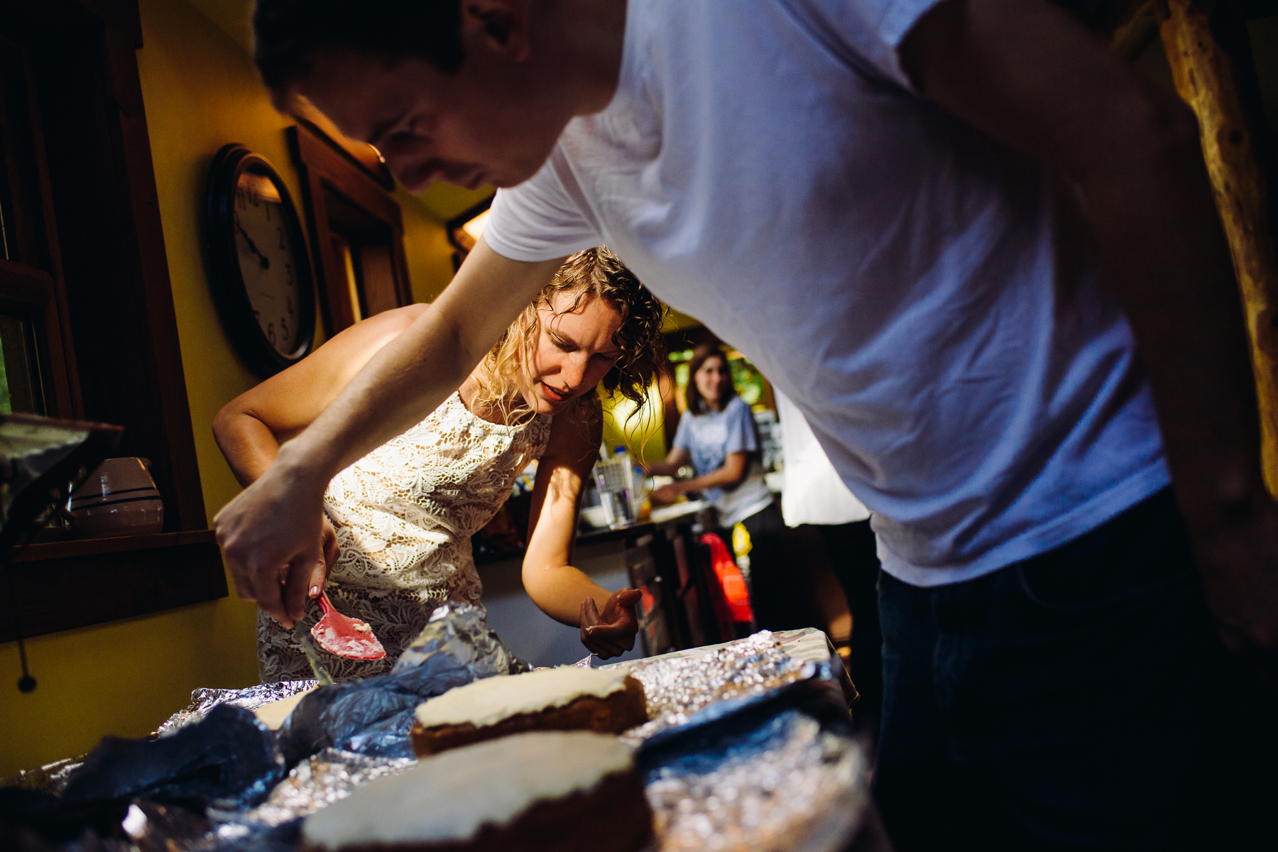 bride and groom making wedding cake