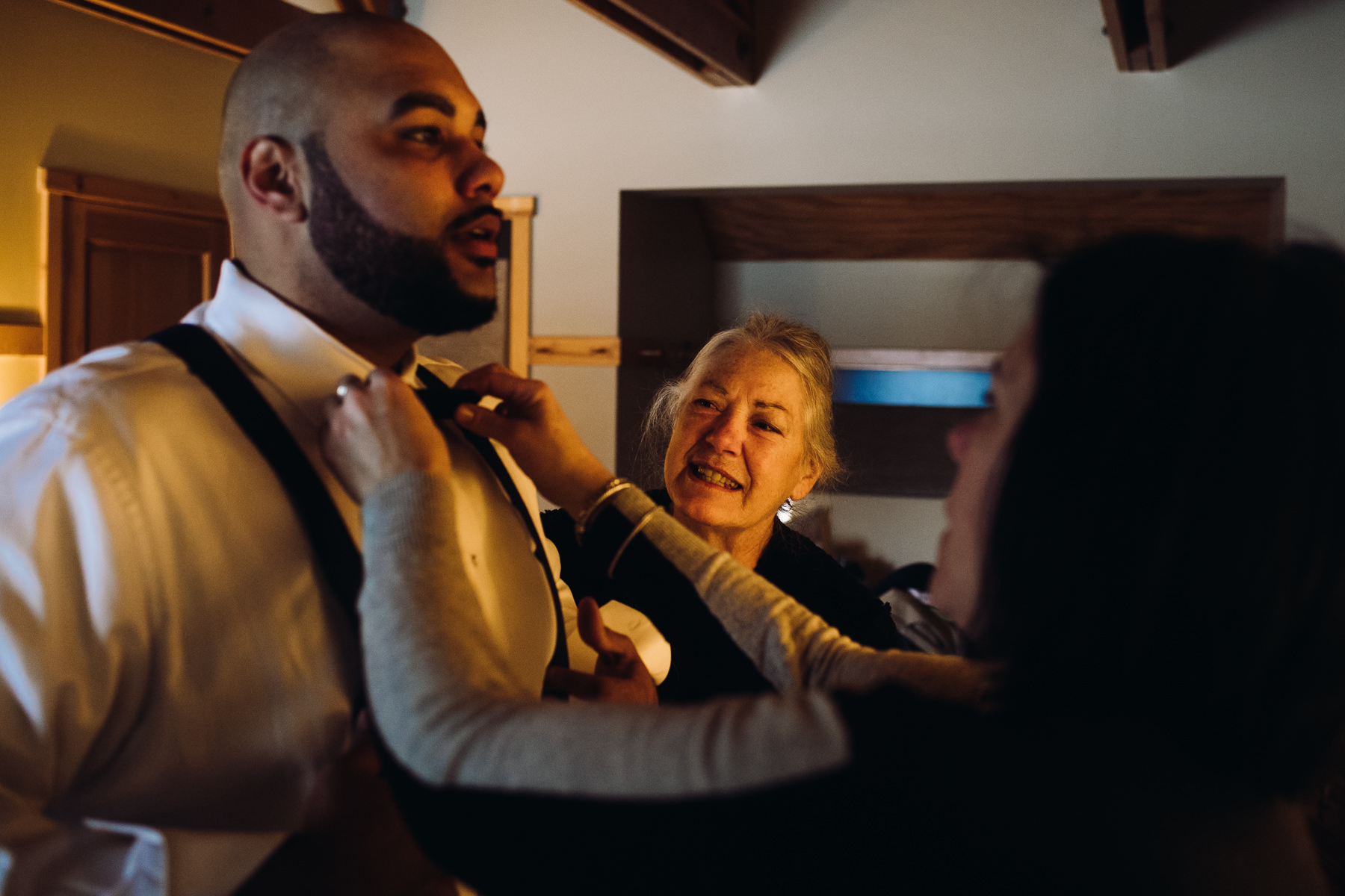 groom getting dressed at sleeping lady resort