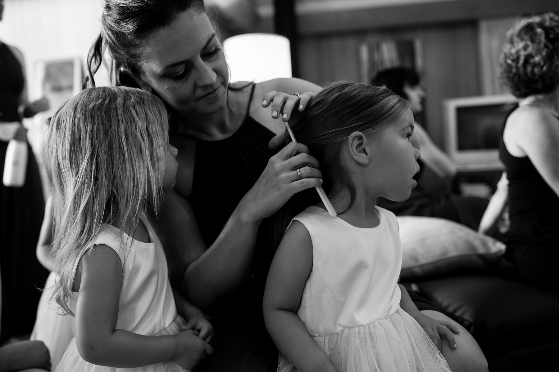 mother combing flower girls hair