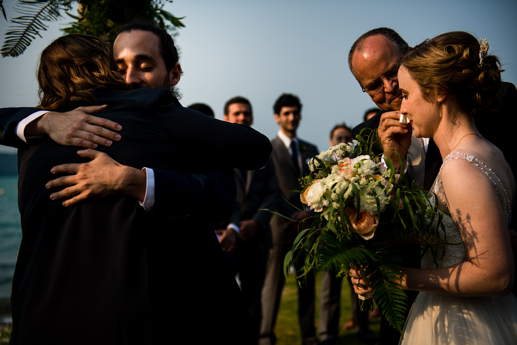 father of the bride wiping brides tear away