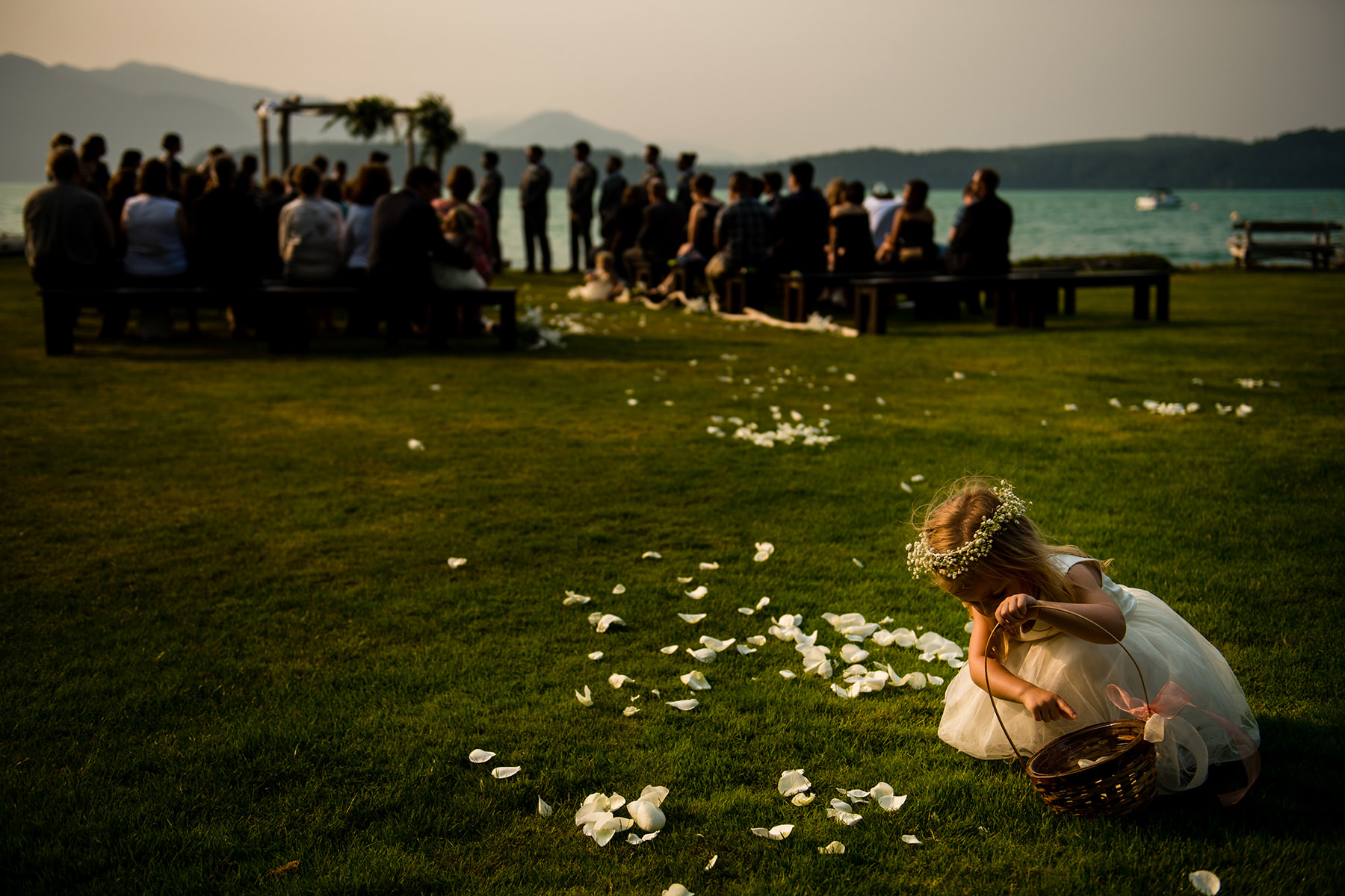 flower girl picking up flowers during wedding