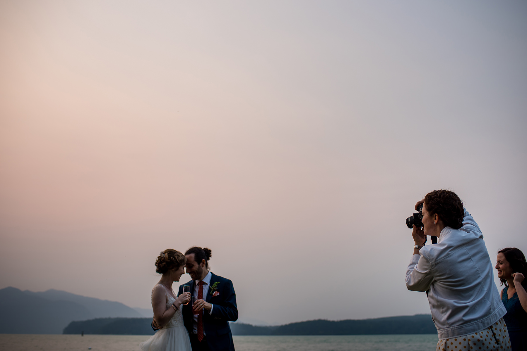 guests taking photos of bride and groom