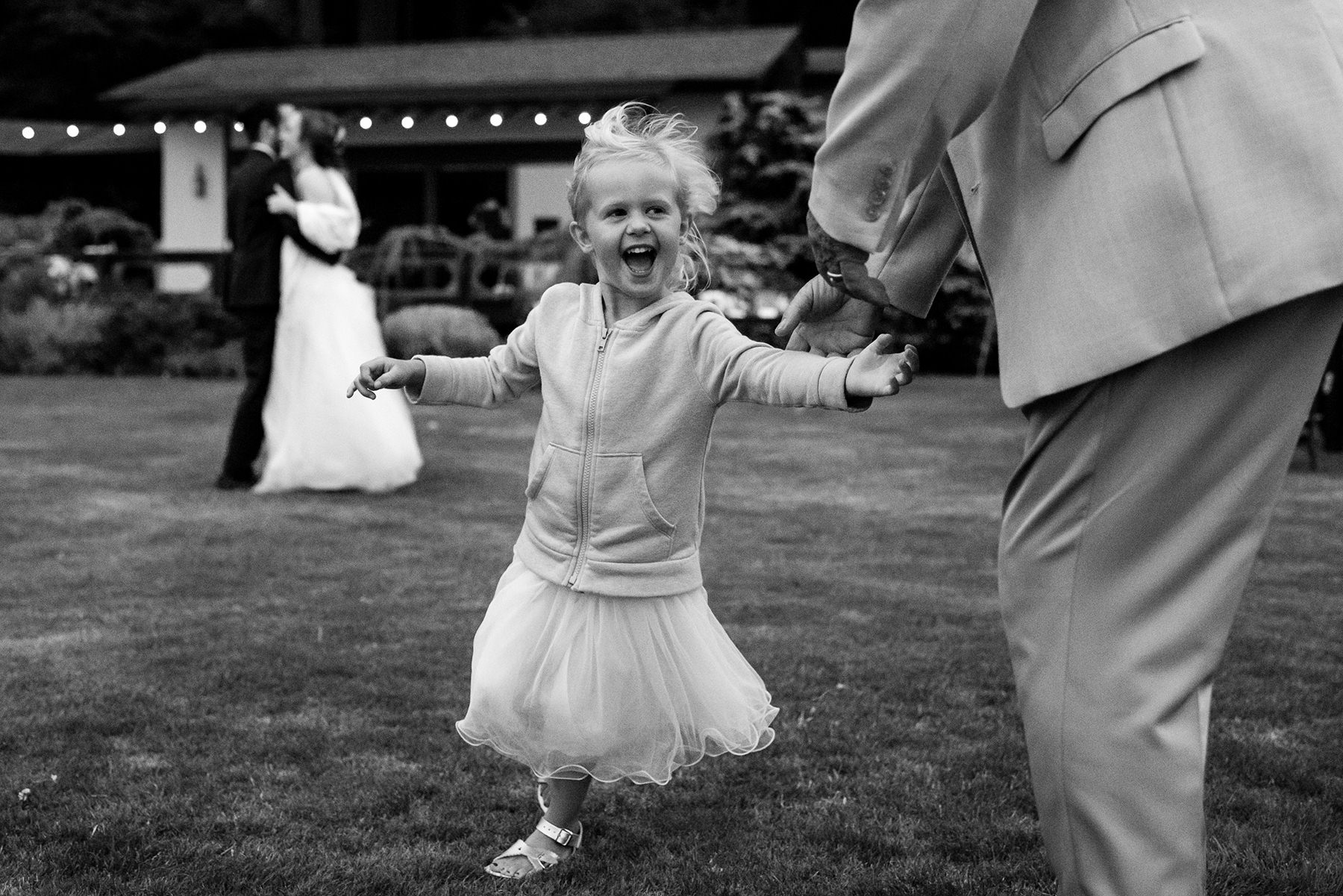 flower girl dancing with great grand father during wedding ceremony