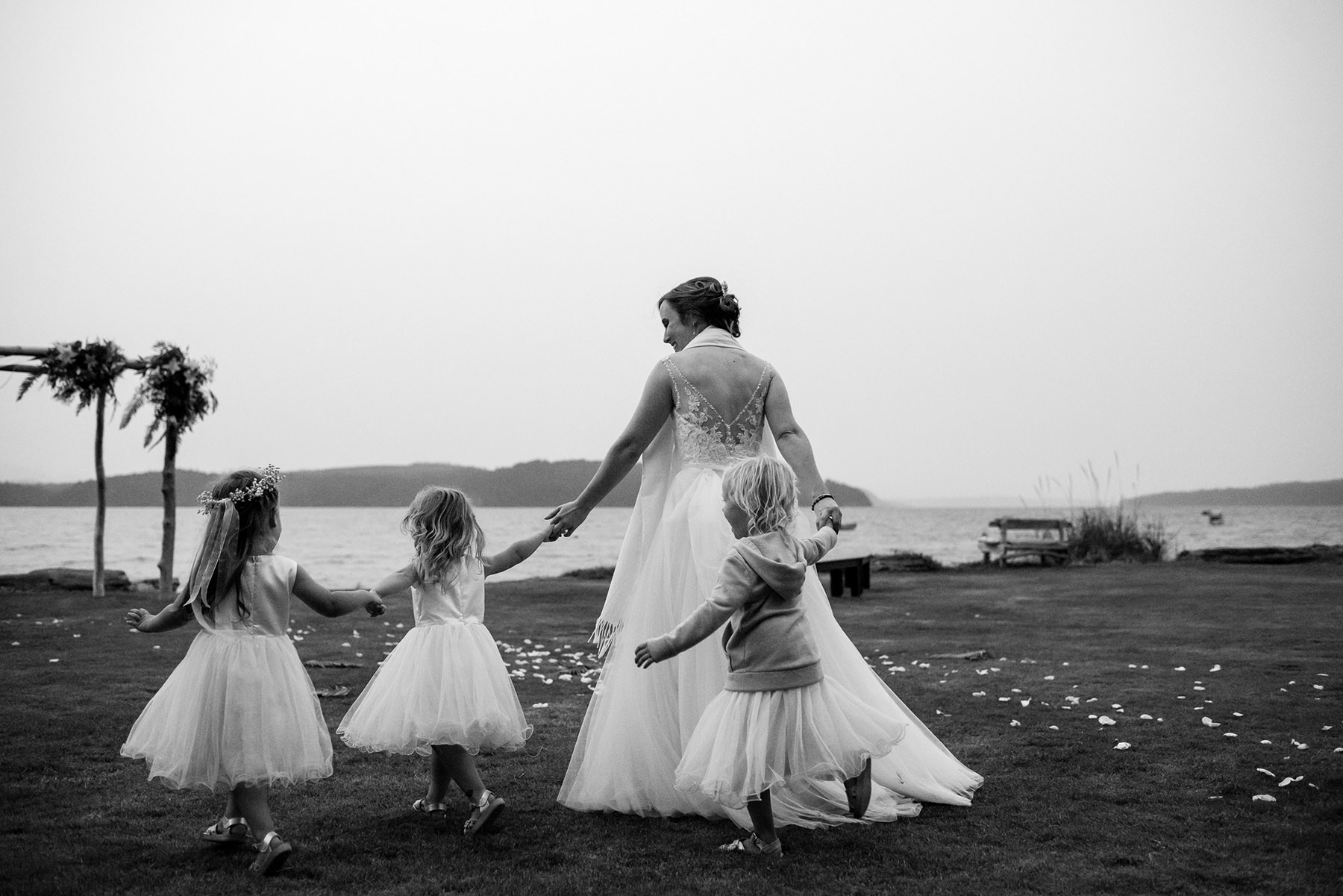bride dancing with three flower girls
