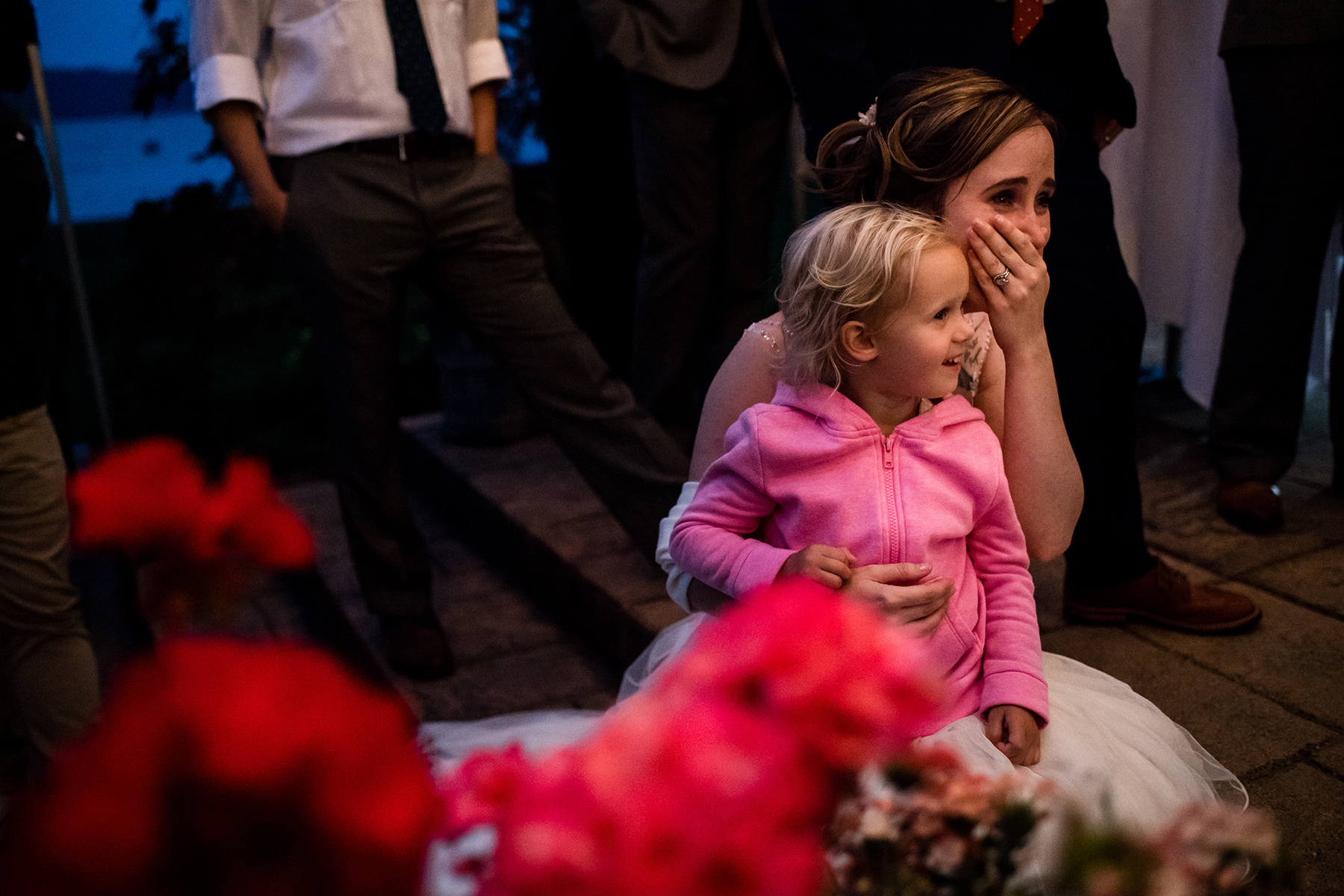 flower girl sitting on brides lap