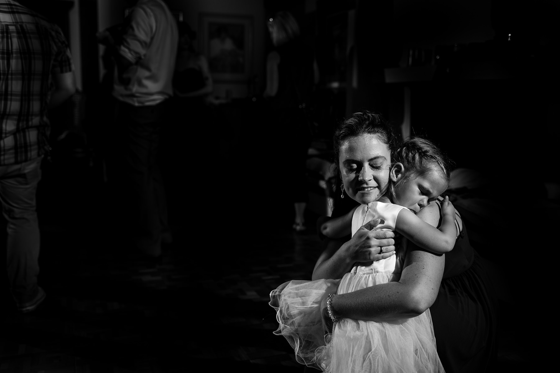 mother hugging flower girl