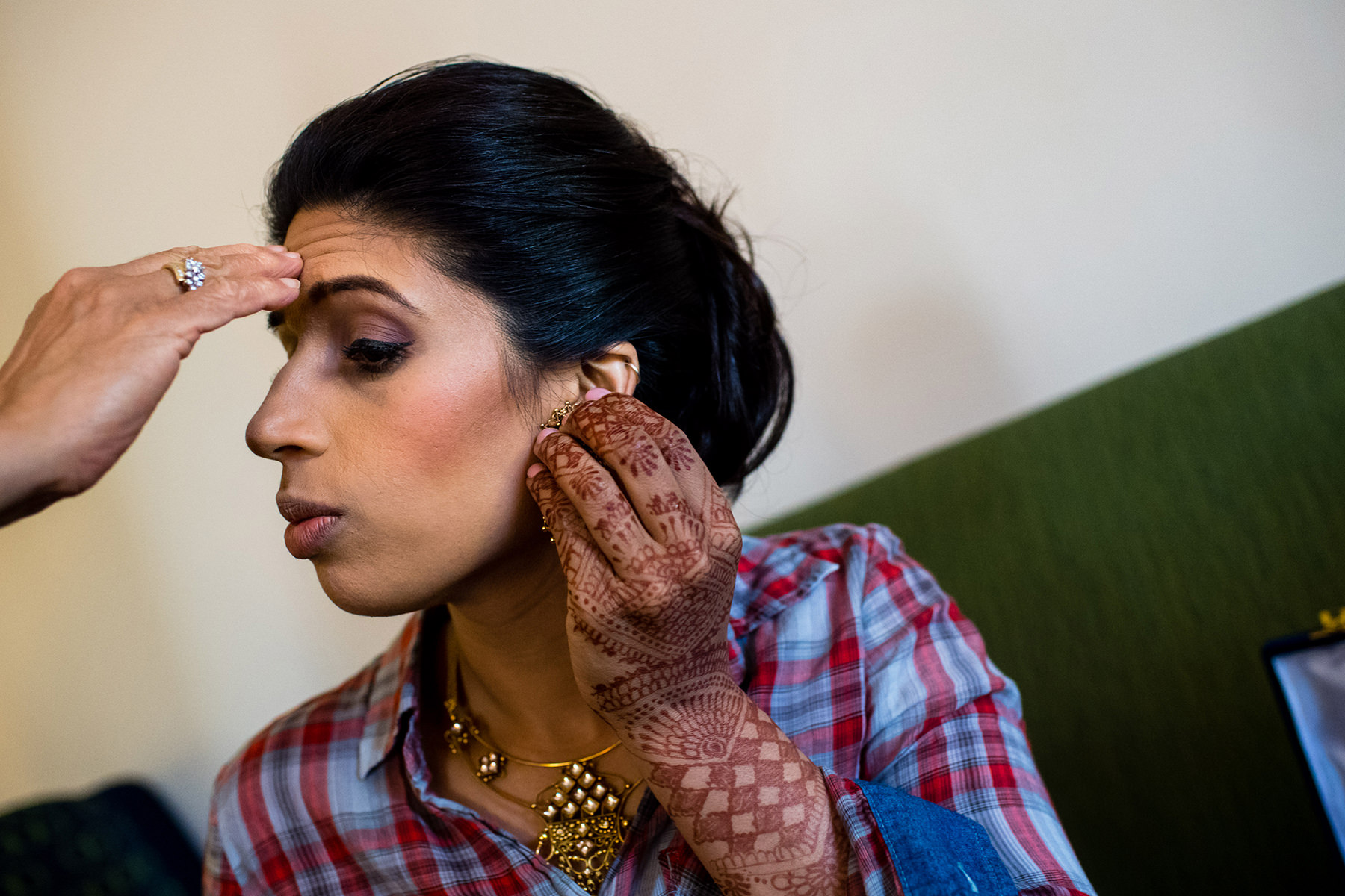 indian bride adding jewelry 