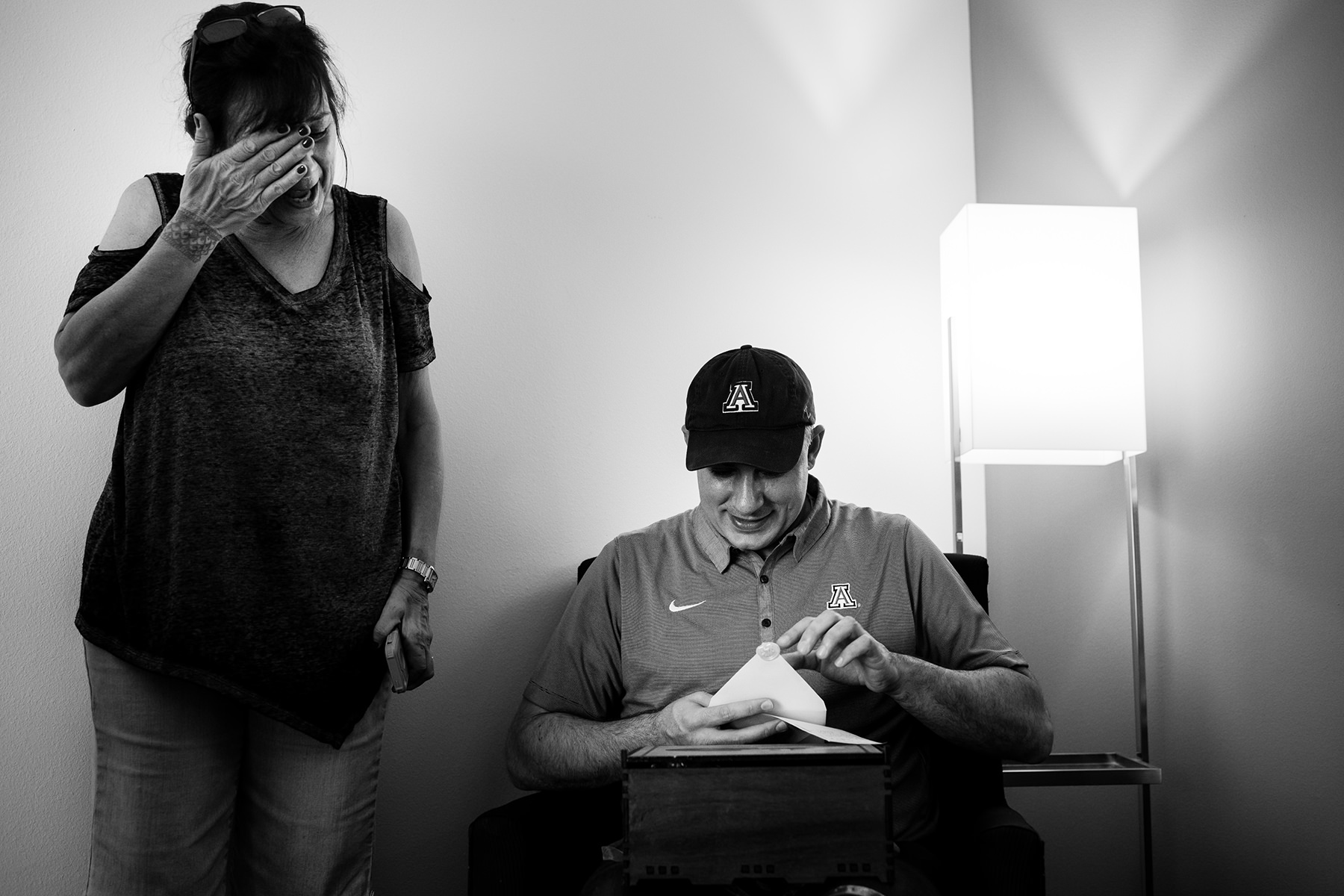 groom opening gift and mother crying