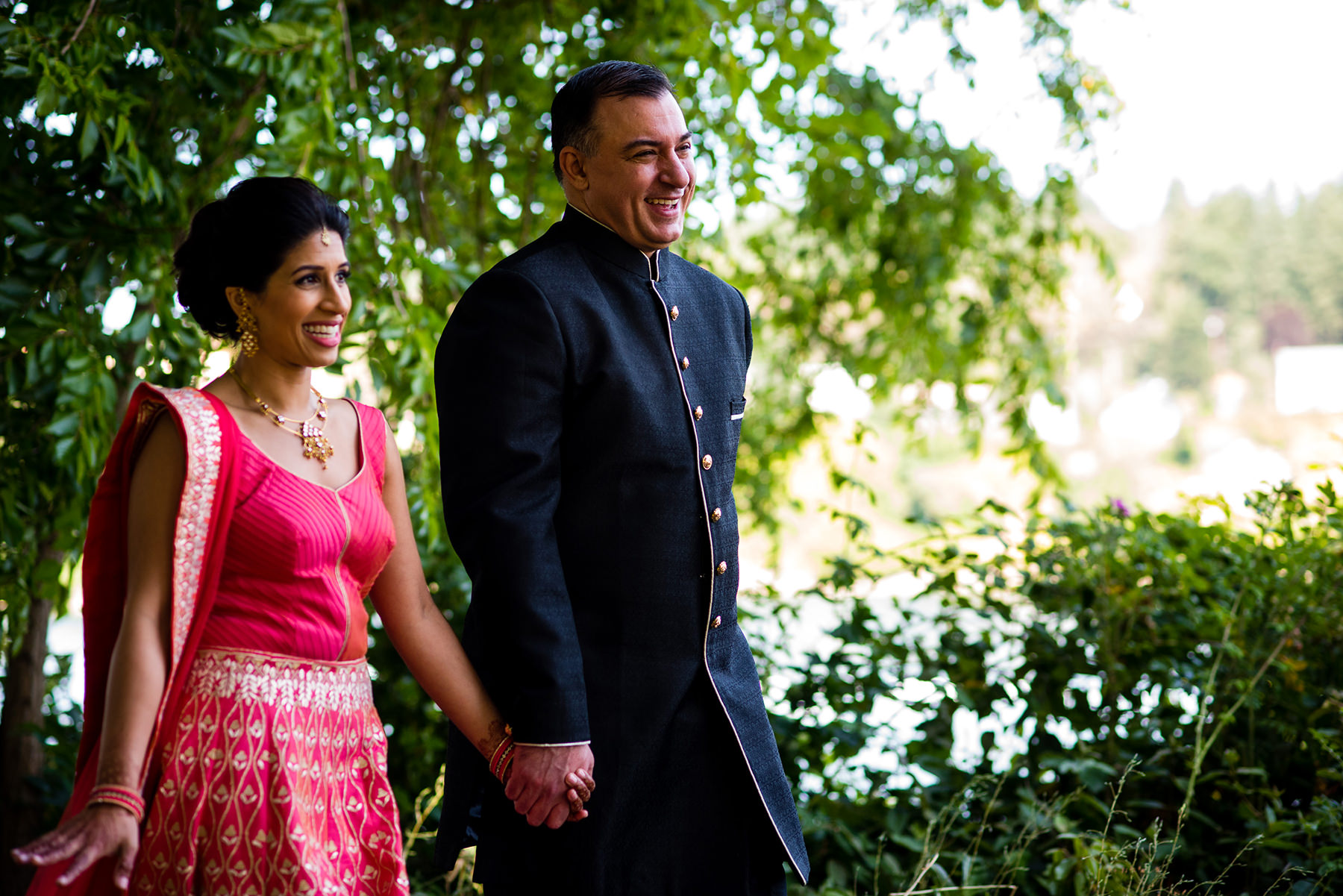 bride and groom walking in park