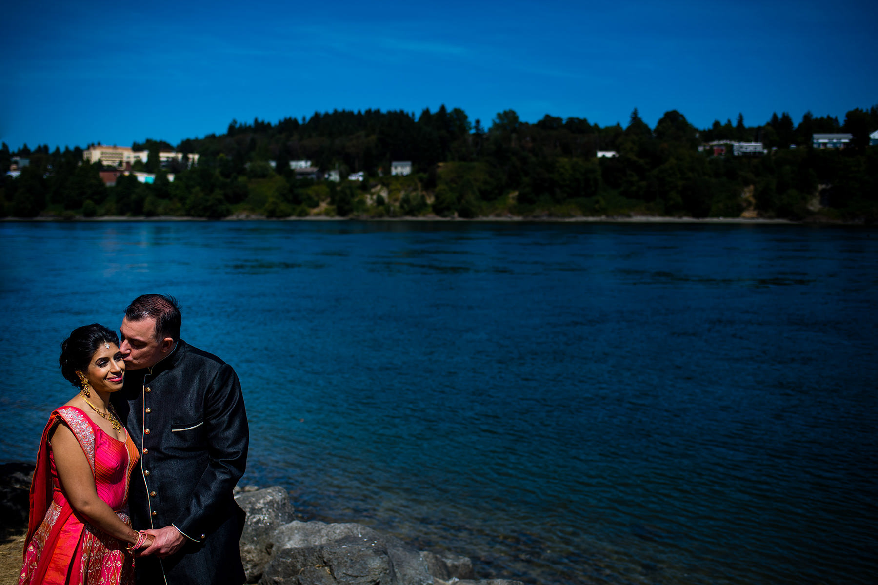 groom kisses brides cheek at evergreen park in bremerton