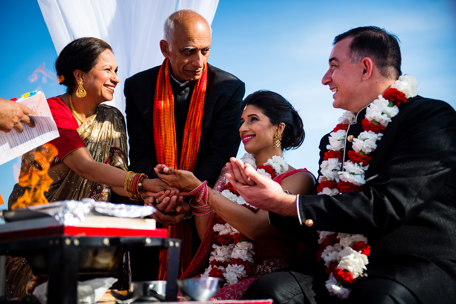families holding hand together during hindu wedding 