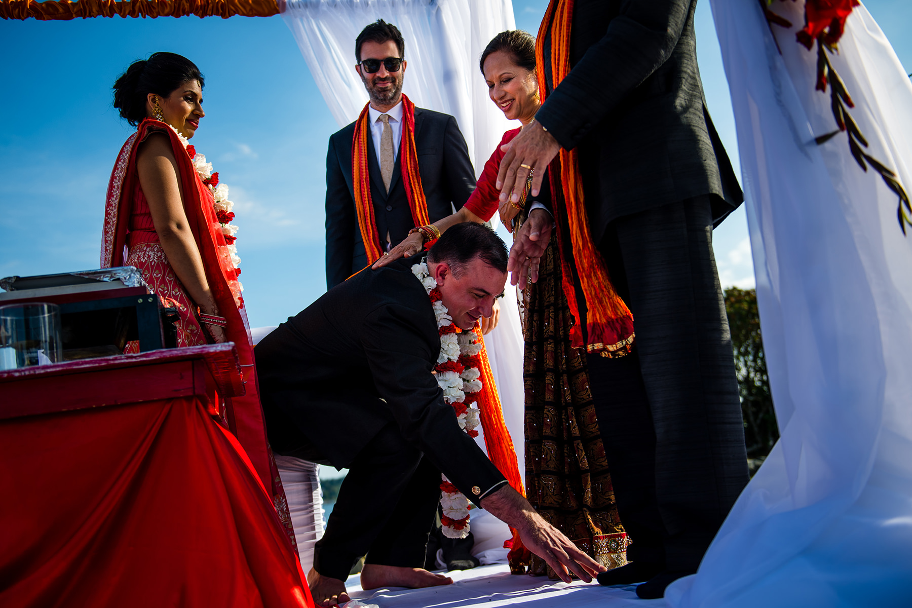 groom touching feet of brides father