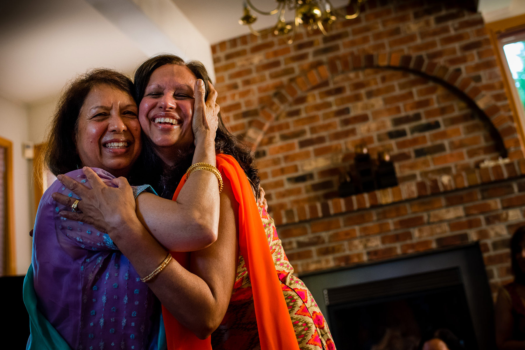 bride mother and friend embrace 